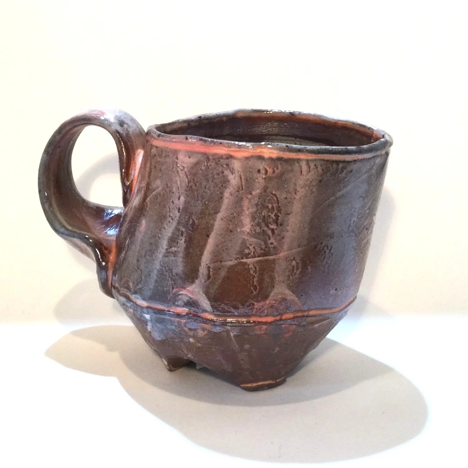 Confluence - Footed Mug (#26.2.81), 2026, low soda-fired earthenware, 3.75 x 5 x 3.5 inches (10 x 13 x 9 cm), $90 Cdn.