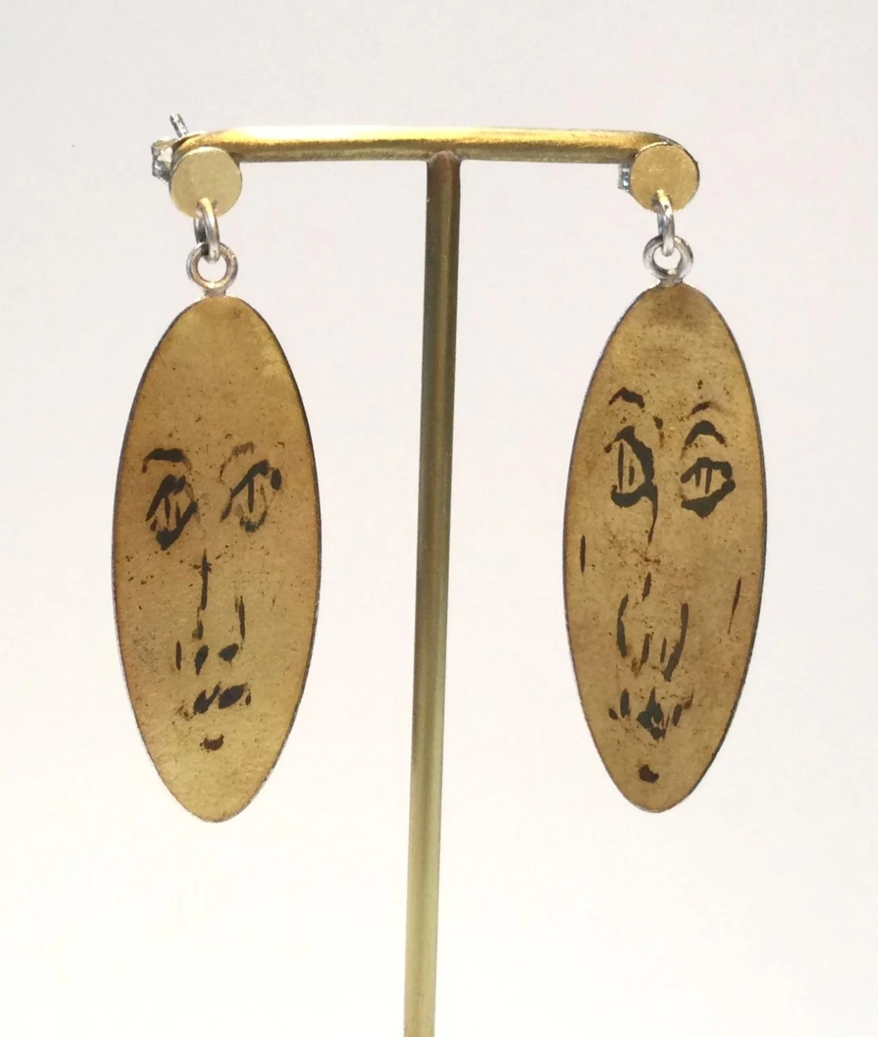 Earrings Carved Face (#276), 1980s, gold doublee, 18 K gold, sterling silver, 1.75 x .5 inches (4.5 x 1.5 cm), $240 Cdn.