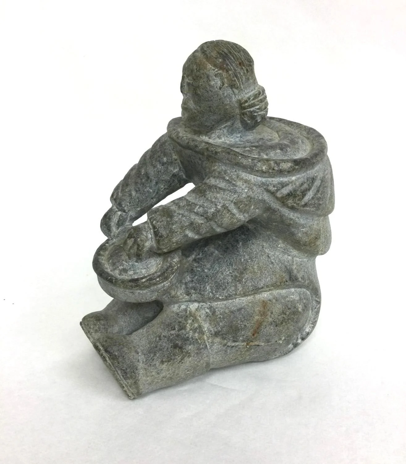 Elisapie Nunivak Papigatok (E9-1217) 1935- (Salluit/Suglak, ᓴᓪᓗᐃᑦ, Nunavik), Woman Sitting (#25.9.18), early 1950s, serpentine, 7 x 5.5 x 3 inches (18 x 13 x 7.5 cm), provenance: Saskatchewan collection, $3100 Cdn.