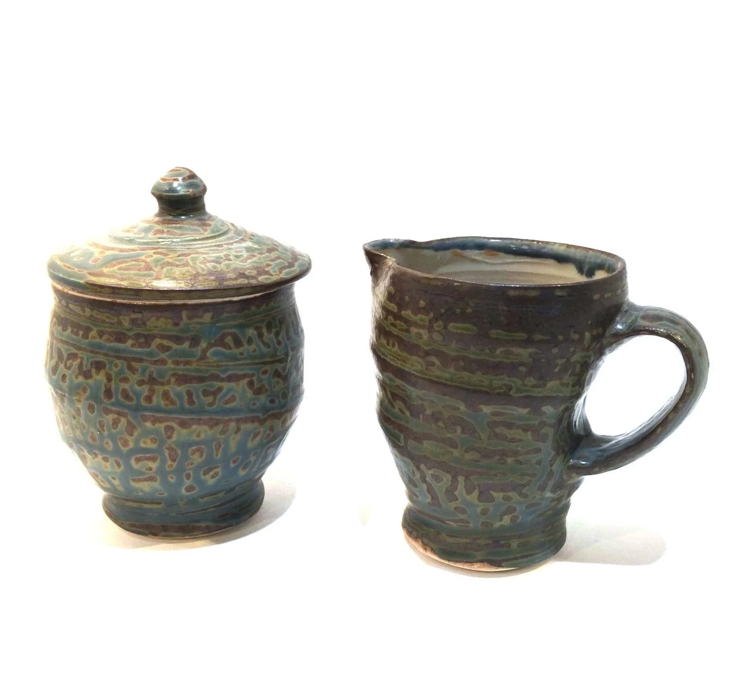 Reduction Fired Cream and Sugar Set (#26.6.31), 2026, reduction fired porcelain, 5.5 inches (14 cm) high, $60 Cdn (set of 2).