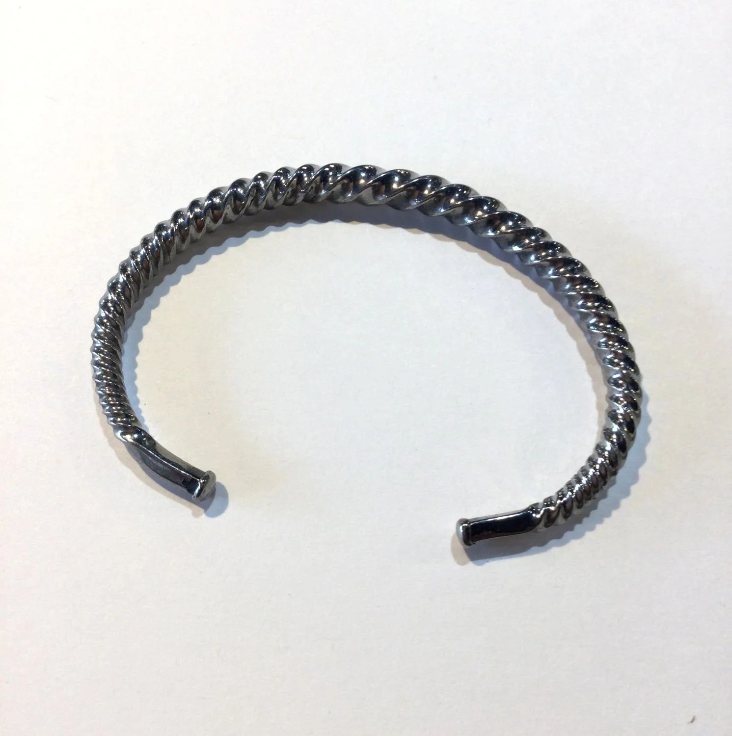 Quantum Wave Bracelet (#244F), 2024, twisted steel, 2.913 x 1.969 x 0.118 inches (7.4 x 5 x 0.3cm), $420 Cdn.