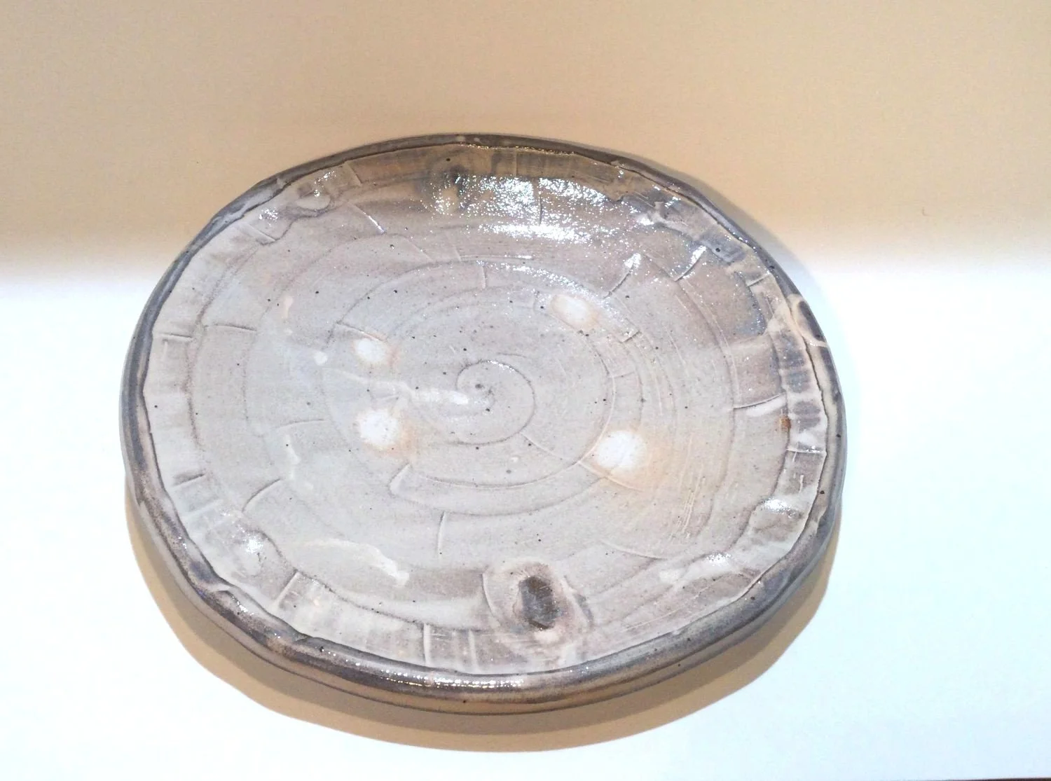 Confluence Side Plate (#26.2.50), 2026, low soda-fired earthenware, 1.25 x 7.5 x 7.5  inches (3 x 19 x 19 cm), $80 Cdn.