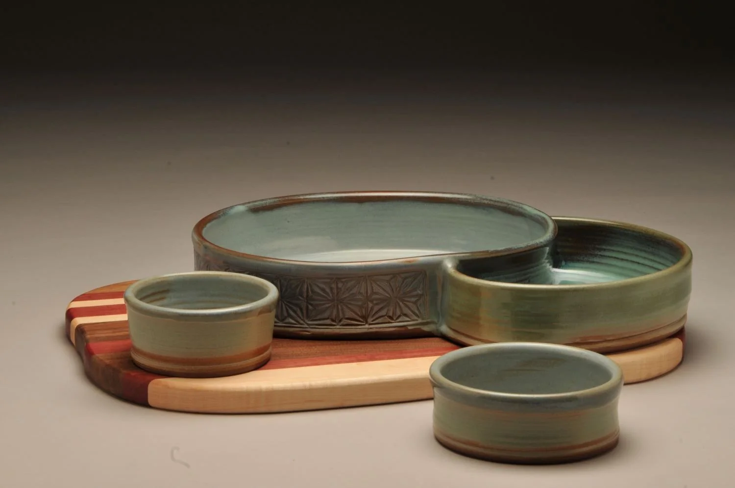 Mountain Pools Triple Chambered Bowl with Striped Wood Charcuterie Board, sold.