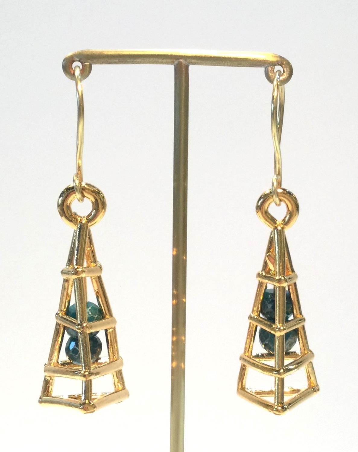 Mayan Cage Series Earring (#279), 2015, thick electroformed 24k gold, emeralds, 18k gold ear wire, fusion welded stainless steel, electroformed copper, 2 x .5 inches (5 x 1.5 cm), $890 Cdn.