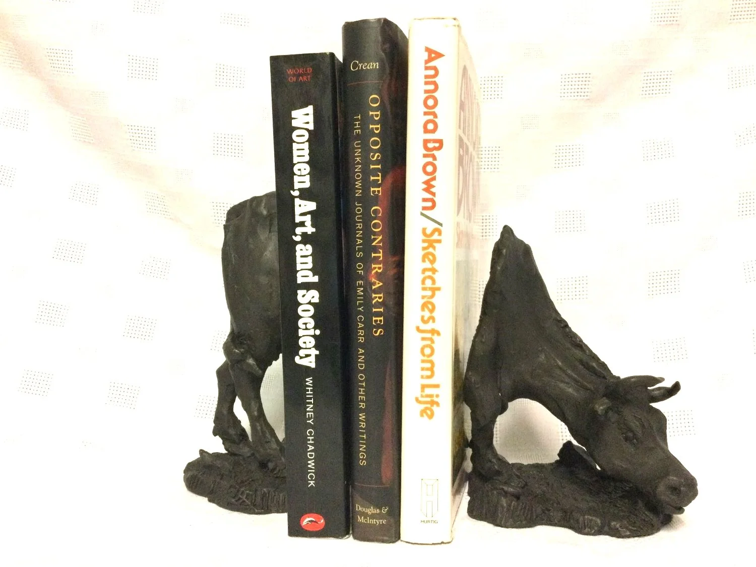 Marsha Schuld, How Now Brown Cow Bookends (dark brown), bronze, edition 5/5, 6 x 4 x 8 inches (15 x 10 x 20 cm), two pieces, $2480 Cdn.