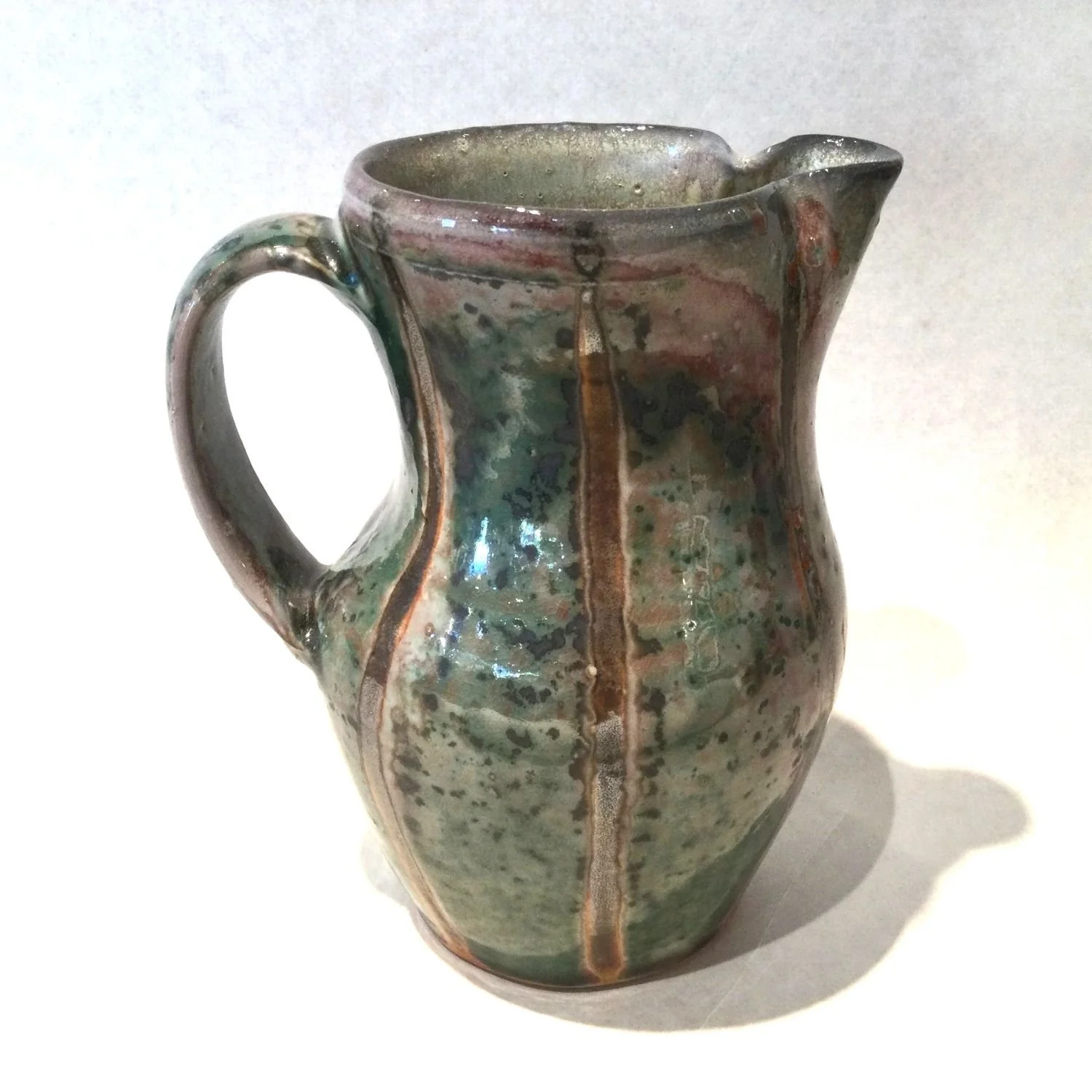 Striped Toward Copper Red Pitcher (#25.7.2), 2025, porcelain, 6.5 x 6 x 5.75 inches (16.5 x 15 x 14.5 cm), $75 Cdn.