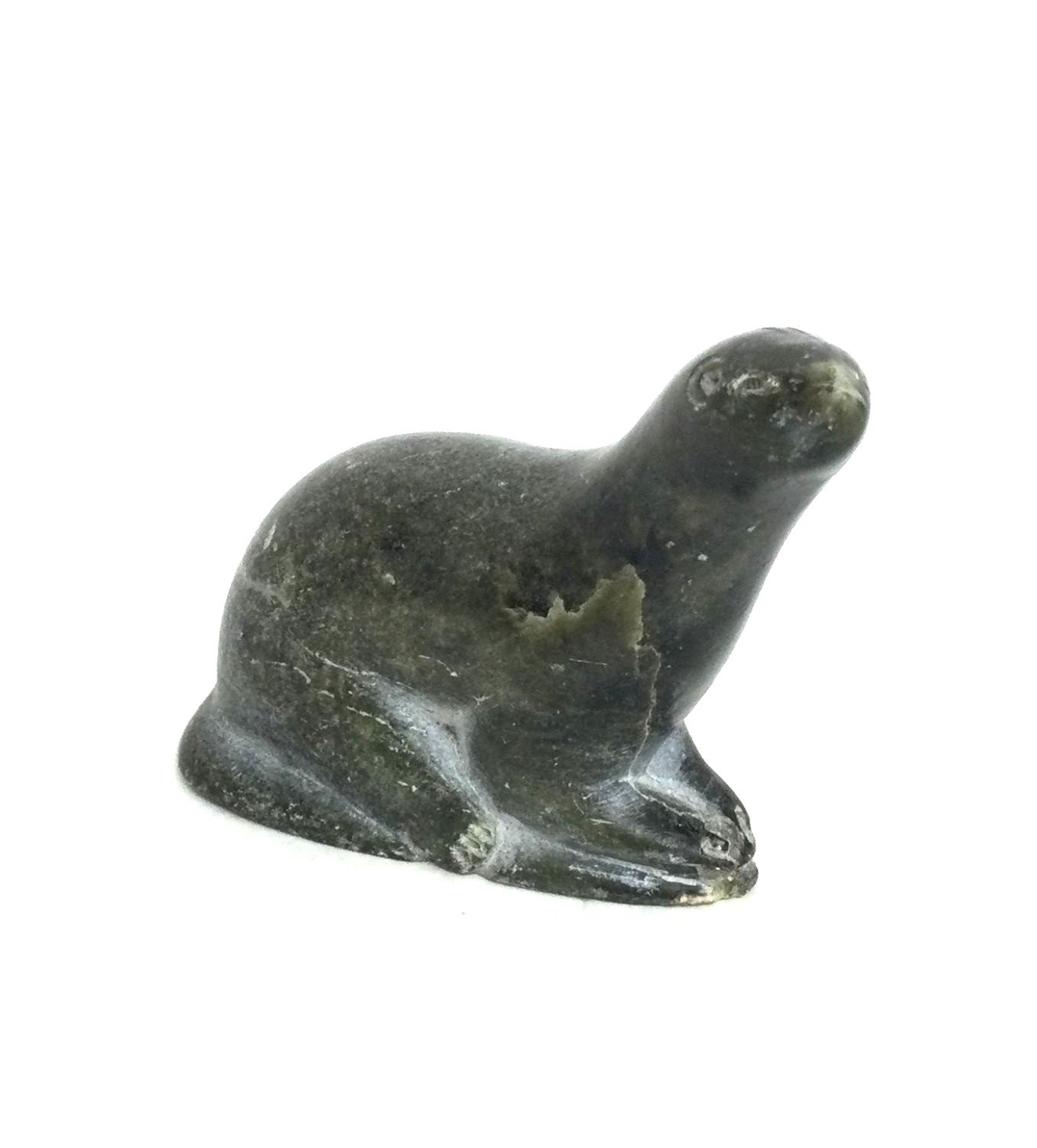 Sam Crow E9-259 (1905-) Belcher Islands / Sanikiluaq ᓴᓪᓚᔪᒐᐃᑦ, Small Seal (#26.1.20), c. late 1950s, steatite/soapstone, 2.5 x 1.25 x 3 inches (6.5x3x8 cm), provenance: private collection Saskatchewan, $250 Cdn.