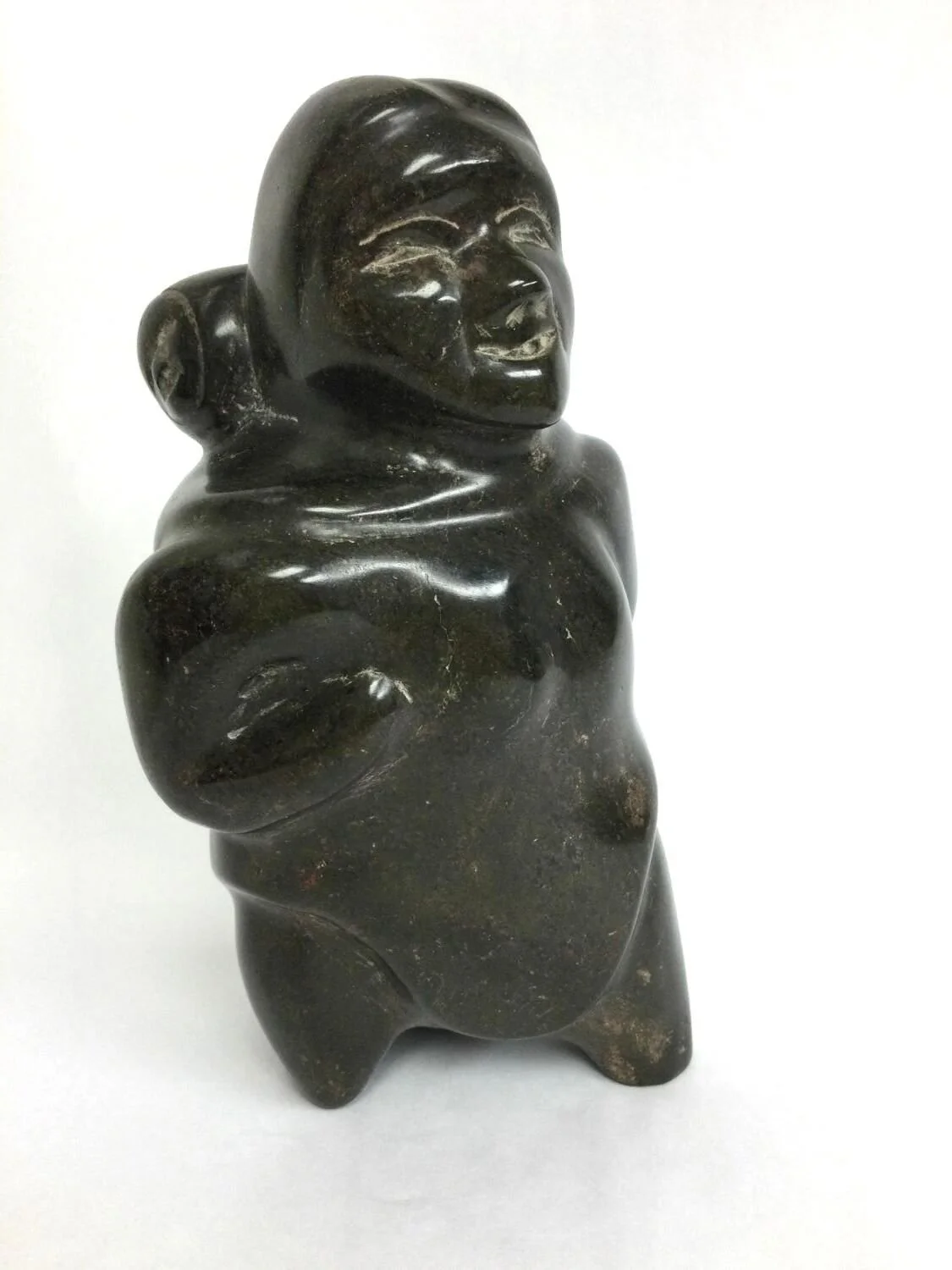 Lucie Eeyaitok Akkuardjuk (E3-625) 1921- Naujaat / Repulse Bay ᓇᐅᔮᑦ, Mother And Child (rare, #25.6.23), n.d., serpentine, 7.75 x 4 x 3.75 inches (19.5 x 10 x 9.5 cm), provenance: Saskatchewan Collection, $850 Cdn.