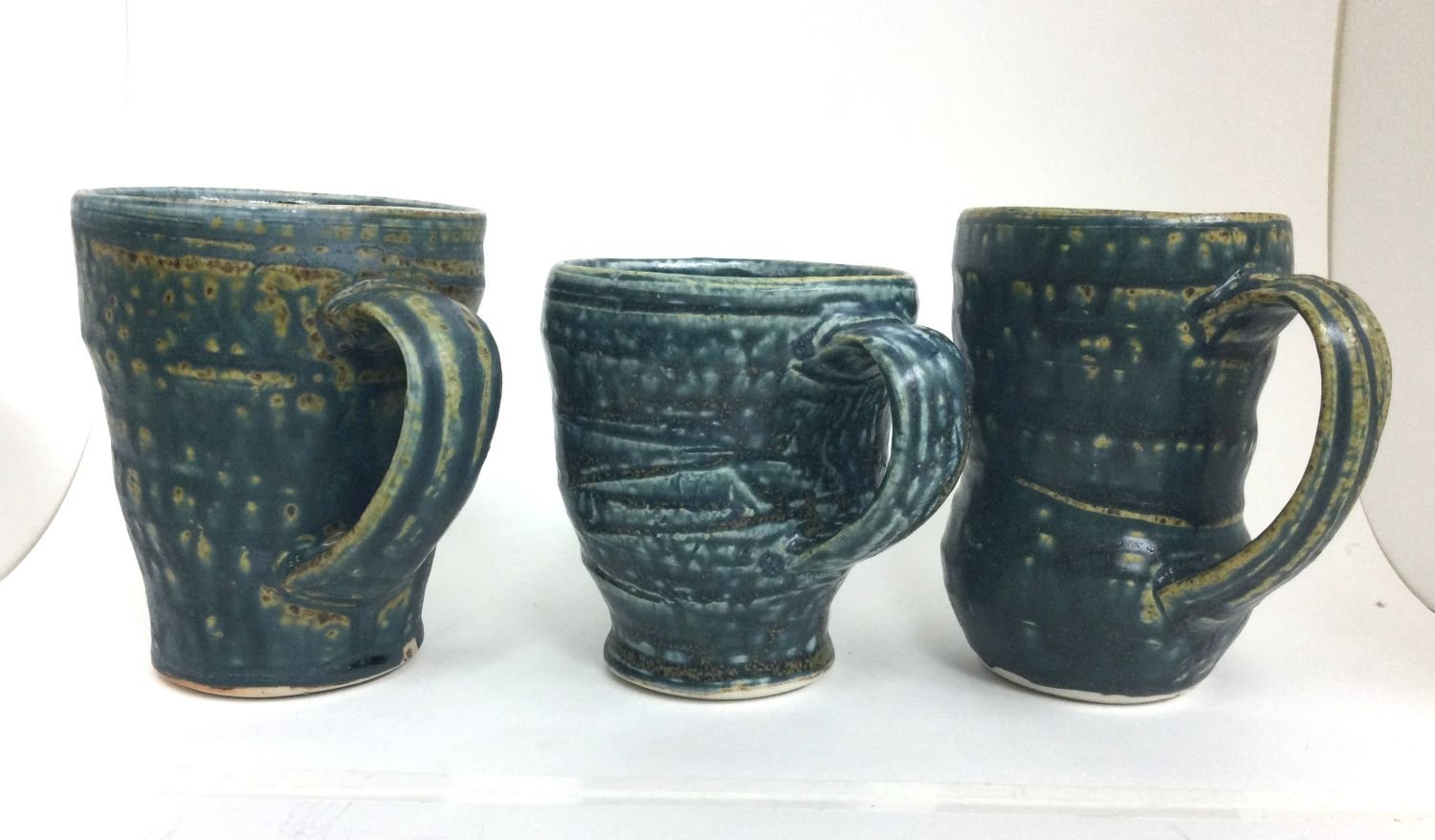 Reduction Fired Medium Sized Mugs (#26.6.36rsz), 2026, reduction fired porcelain, 4.5 x 4 x 3.25 inches (11.5 x 10 x 8.5 inches) $45 Cdn each