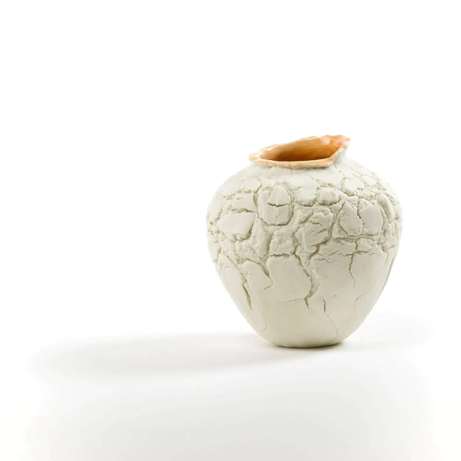 Orange Vase (#25.8.5), 2025, pinched porcelain, unglazed exterior with orange glaze interior, 4 x 3.75 inches (10.2 x 9.7 cm), $130 Cdn.