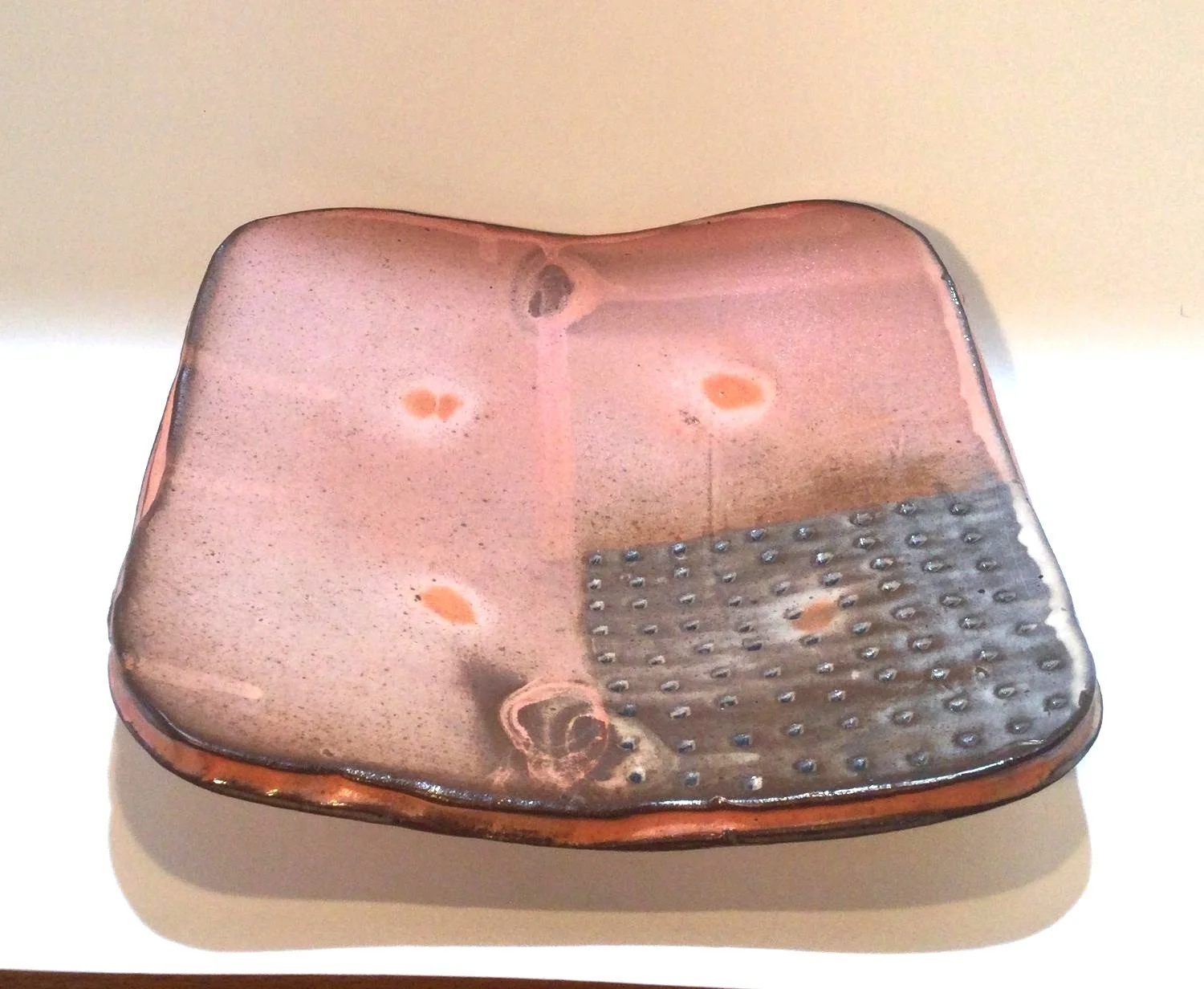 Confluence - Square Plate (#26.2.52), 2026, low soda-fired earthenware, 1.75 x 7 x 7 inches (4 x 17.5 x 17.5 cm), $80 Cdn.