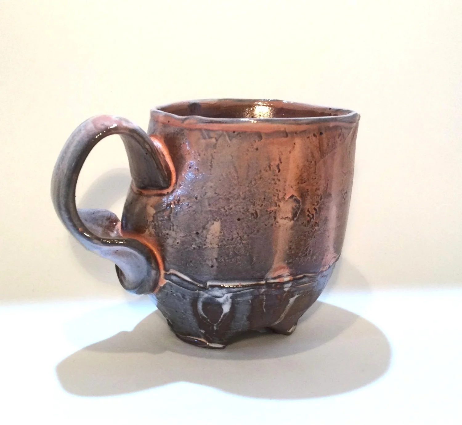 Confluence - Footed Mug (#26.2.82), 2026, low soda-fired earthenware, 3.75 x 5 x 3.5 inches (10 x 13 x 9 cm), $90 Cdn.
