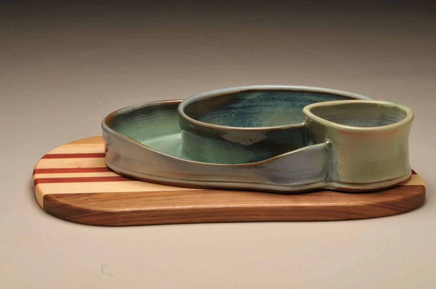 Mountain Pools Triple Chambered Bowl with Striped Wood Charcuterie Board, sold.