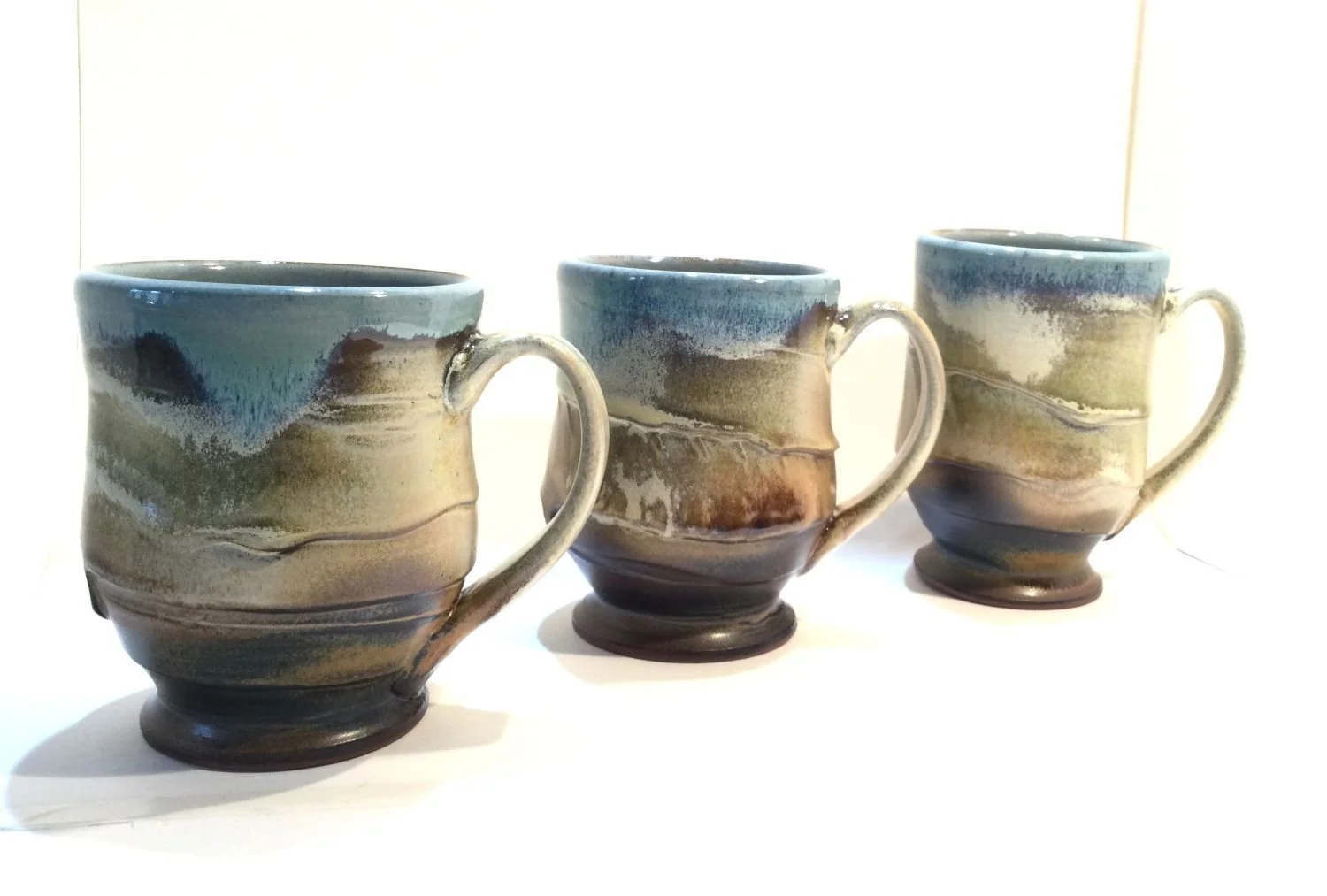 Blue Skies & Prairie Mugs (#26.18ghi), 2026, glazed stoneware, 4.5 x 5 x 3.5 inches (11 x 12.5 x 9 cm), sold