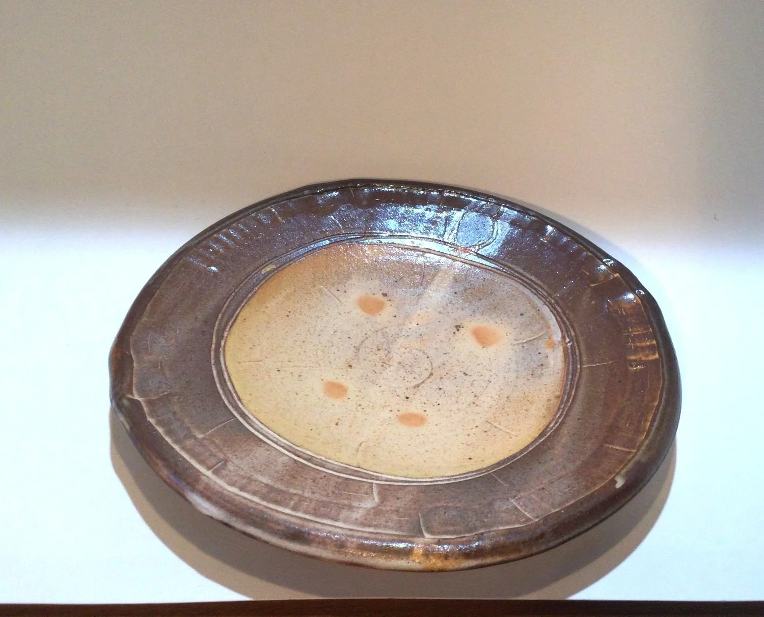 Confluence Side Plate (#26.2.46), 2026, low soda-fired earthenware, 1.25 x 7.5 x 7.5  inches (3 x 19 x 19 cm), $80 Cdn.