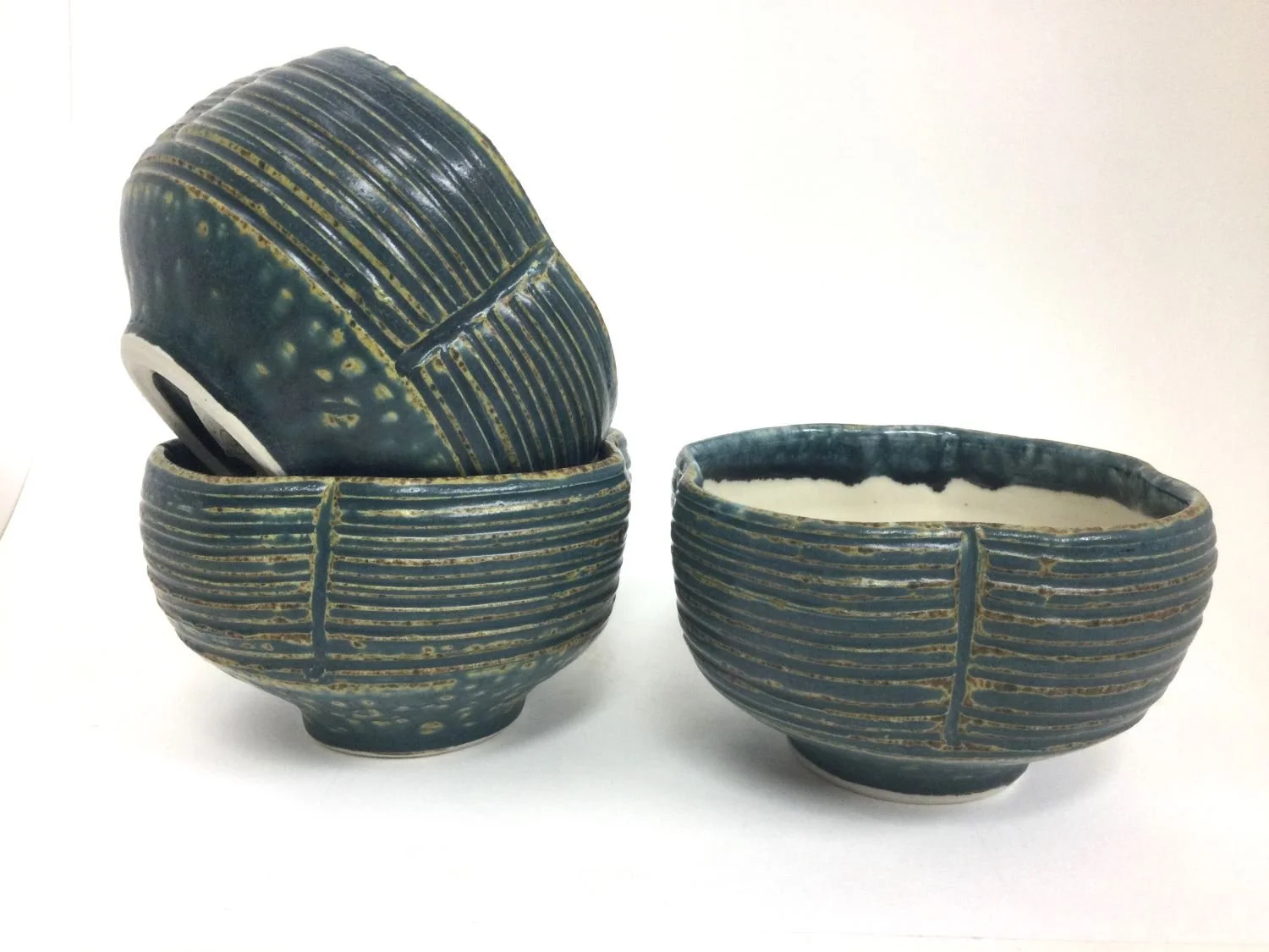 Wavy Reduction Fired Medium Sized Bowls (#26.6.33abc), 2026, reduction fired porcelain, 2.75 x 4.5 inches (7 x 11 cm) $40 Cdn each