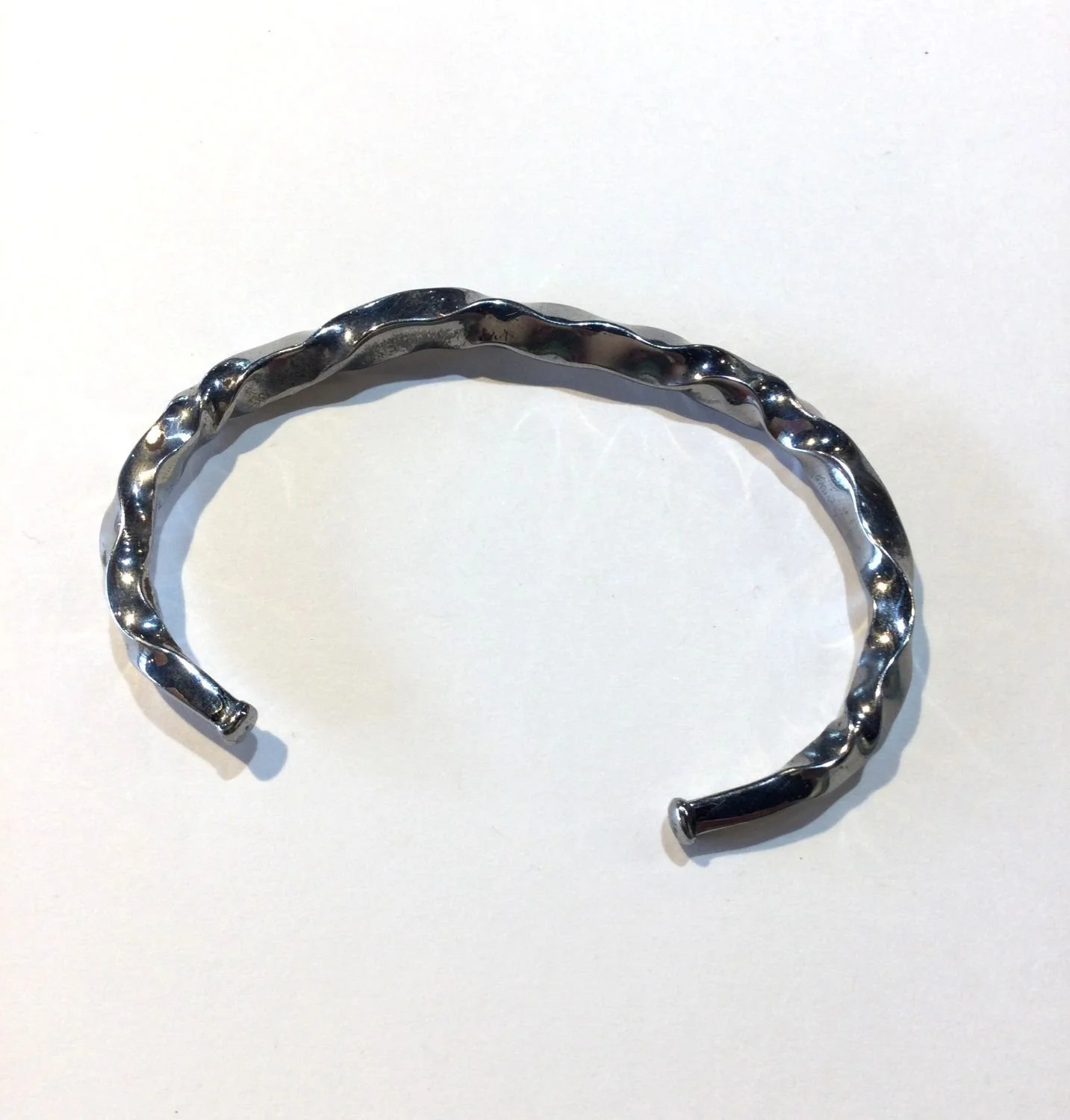 Quantum Wave Bracelet (#244E), 2024, twisted steel, 2.913 x 1.969 x 0.118 inches (7.4 x 5 x 0.3cm), $420 Cdn.