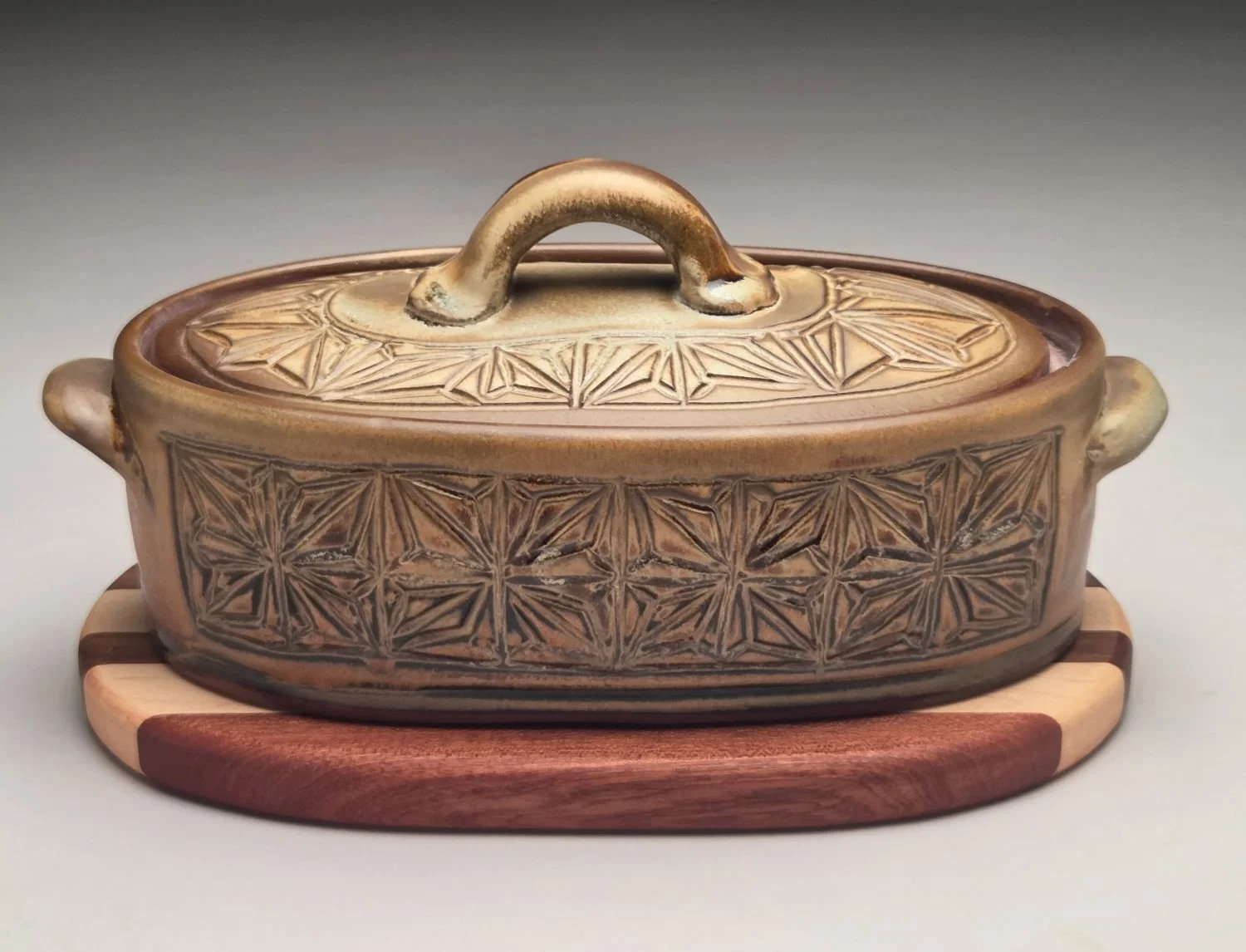 Kumiko Blue Skies & Prairie Fields Casserole with Wood Trivet (med #26.5.13a), 2026, hand carved & glazed stoneware, handcrafted wood, 6 x 6.5 x 11.5 inches (15 x 16.5 x 29  cm), $275 Cdn.