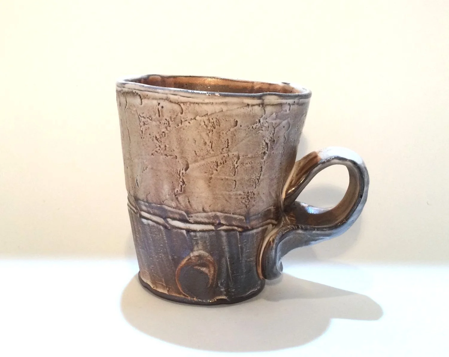 Confluence - Straight Mug (#26.2.64), 2026, low soda-fired earthenware, 4.25 x 4.75 x 3.25 inches (11 x 12 x 9 cm), $85 Cdn.
