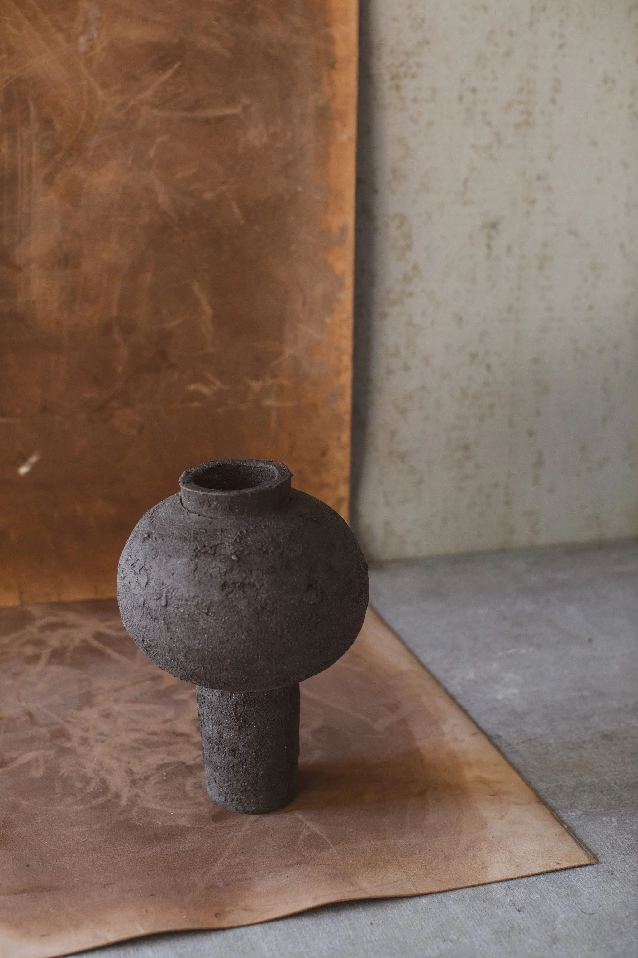 Handmade ceramic moon jar with textured black clay surface