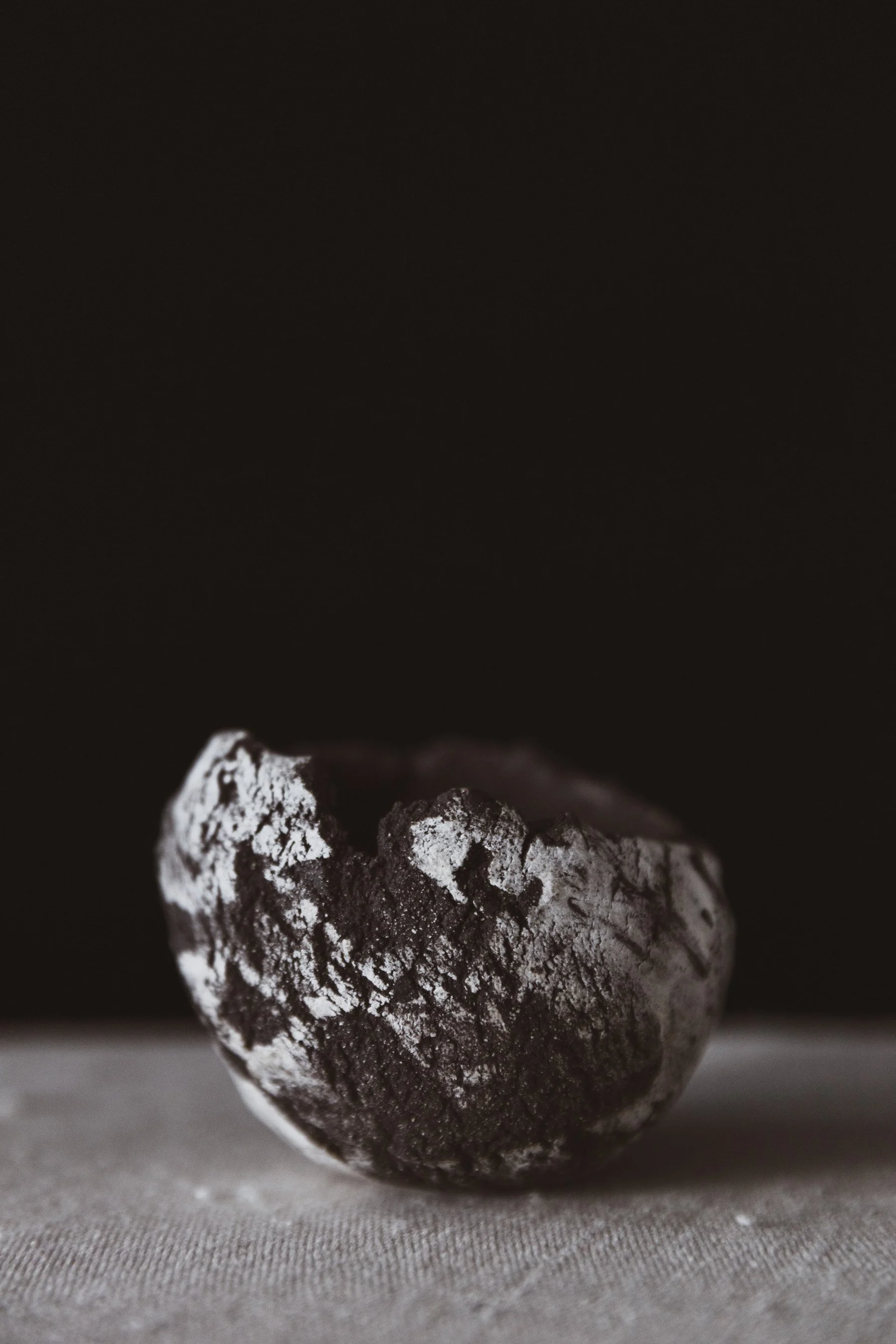 Small handmade ceramic vessel with textured surface in dark clay with white slip.jpg