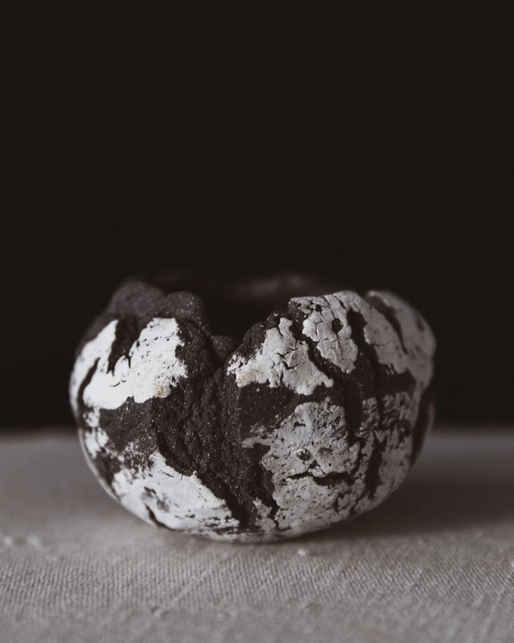 Small handmade ceramic vessel with textured surface in dark clay with white slip.jpg
