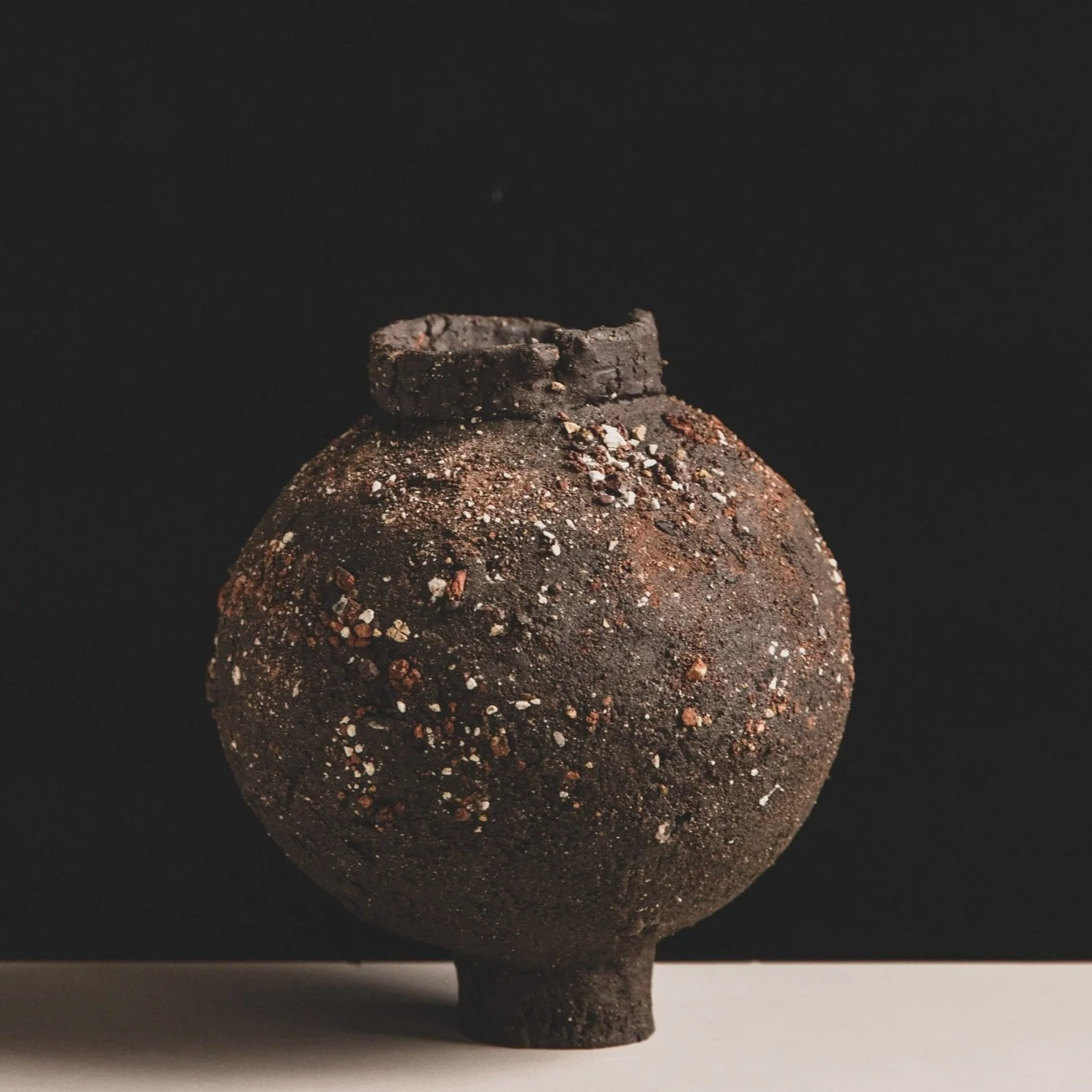 Handmade ceramic moon jar with textured black clay surface