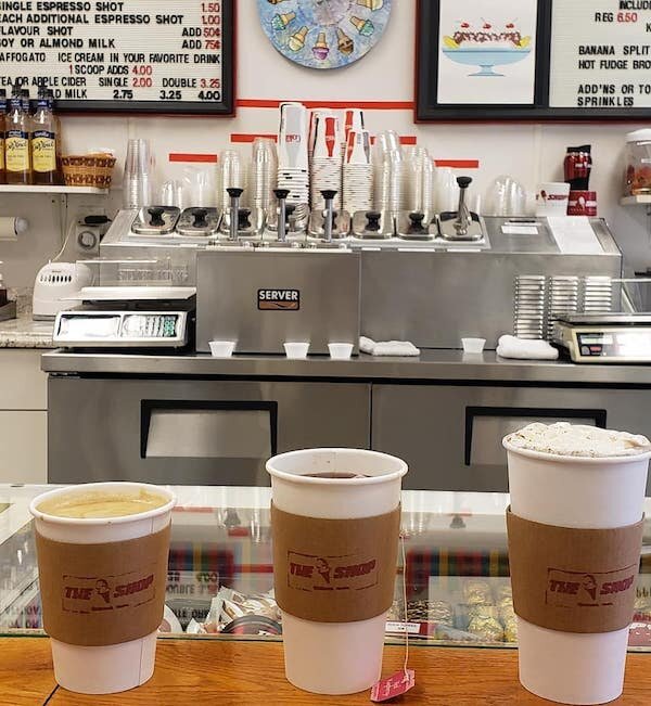  Three cups of coffee lined up on a counter in the Ice Cream Shop 