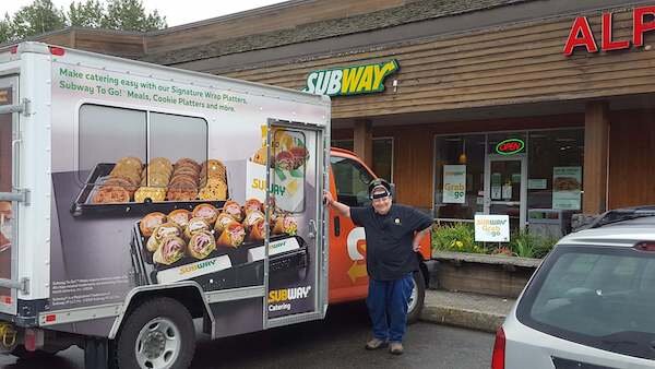  Delivery truck and driver outside the Subway of Girdwood 