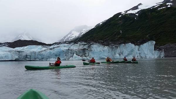  Kayakers gliding along a glacier with Alaska Backcountry Access 