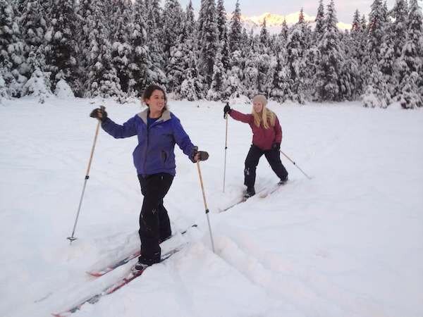  Two skiers cross country skiing with Alaska Backcountry Access 