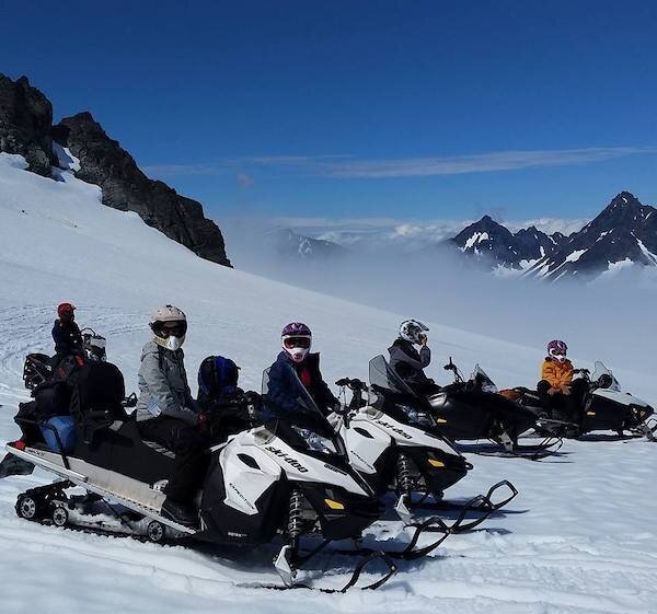  A group of people on snowmobiles  on a tour with Alaska Backcountry Access 