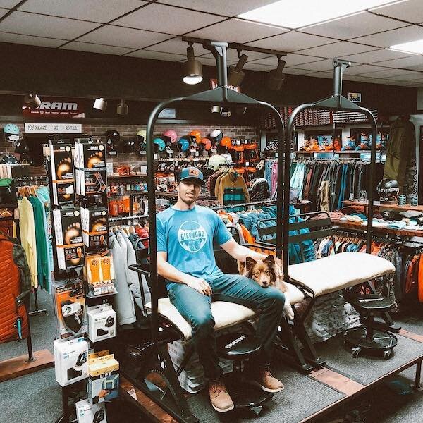  A person sitting in a chairlift in a store used for boot fitting 