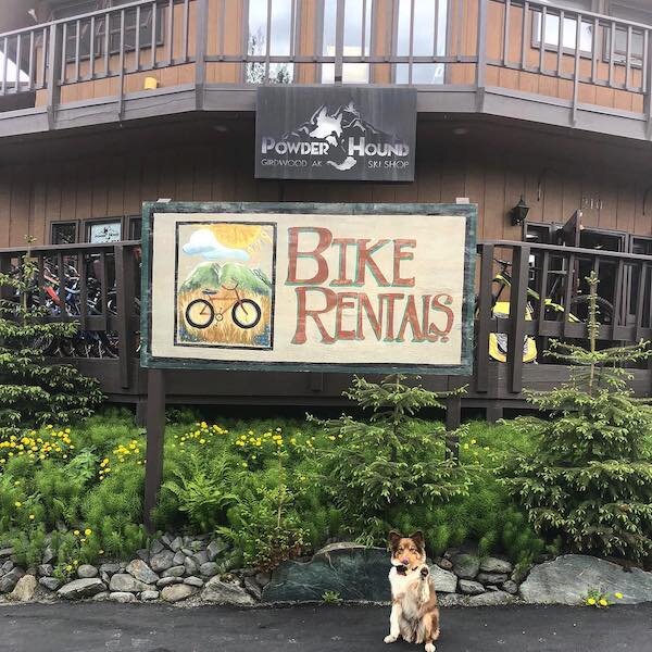  The outside of Powder Hound with a sign 
