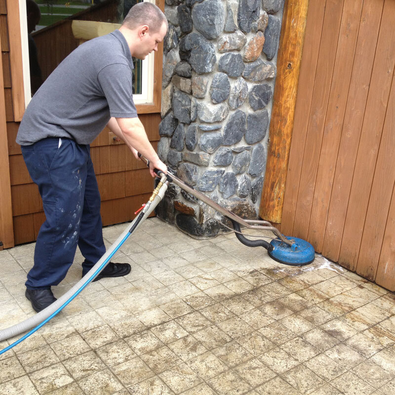  A worker cleaning a floor with a machine for Alaska Stone Care 