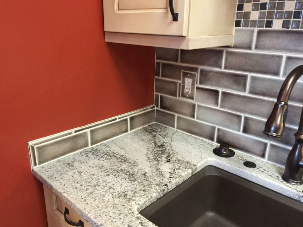  A sink with a wall painted orange done by Alaska Stone Care 