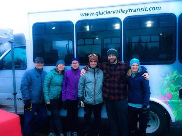  A group of people standing next to a Glacier Valley Transit van 
