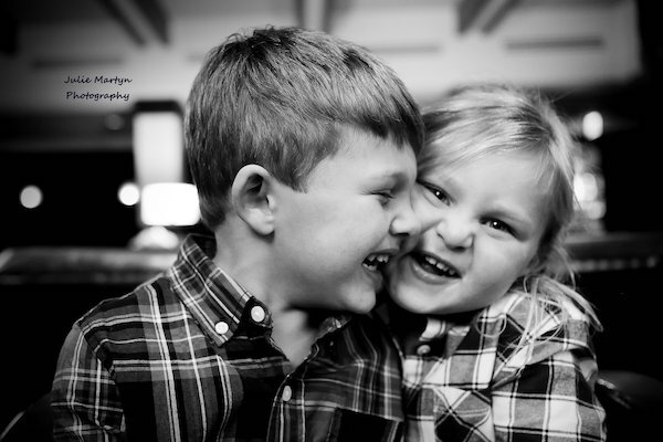  Two kids hugging and laughing with photo taken by Julie Martyn Photography 