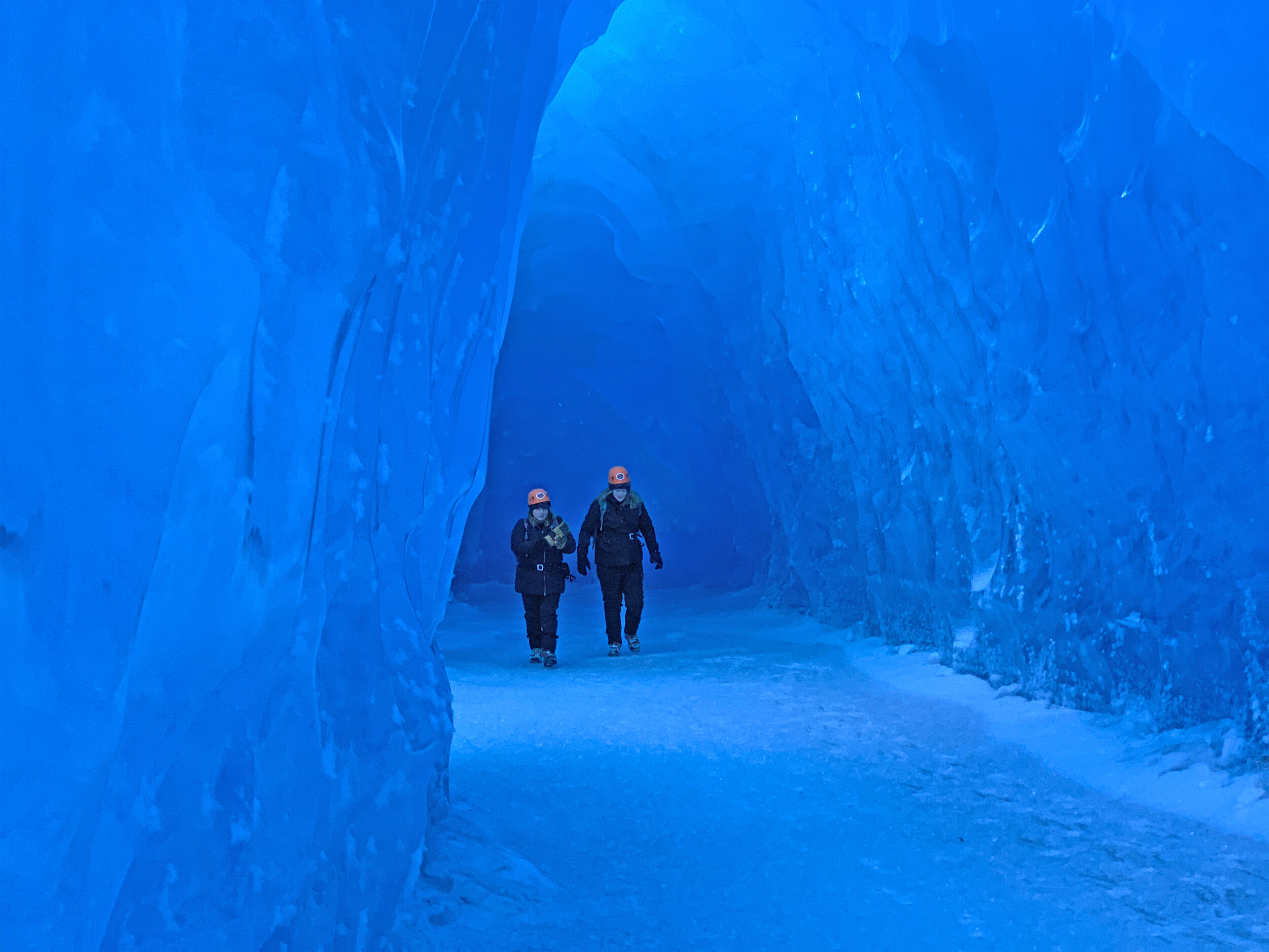  People walking in an ice cave  