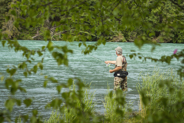  A man fly fishing on the Kenai River near Alaska Wildland Lodge 