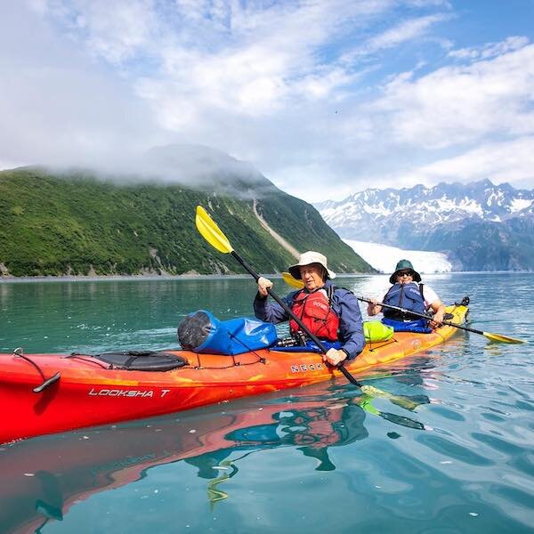  Two kayakers paddling in the ocean near Alaska Wildland Lodge 