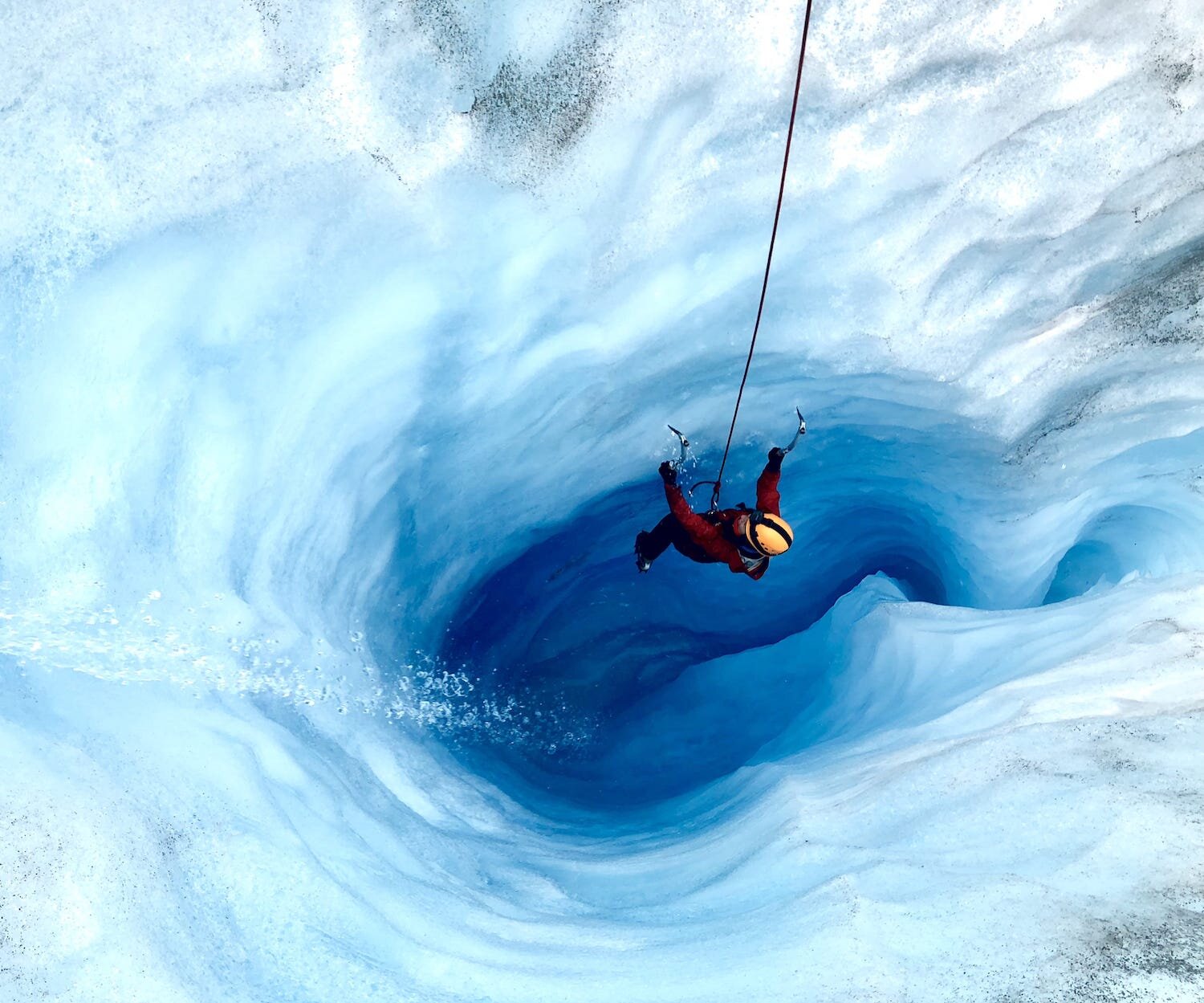  A person rappeling down into an ice cave 