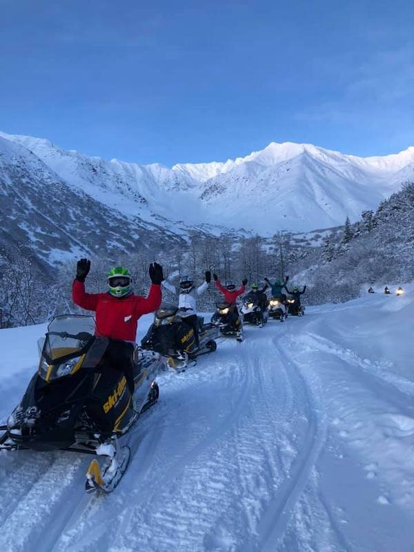  Snow Mobile riders cheering while Snowmobiling with Glacier City Snowmobile Tours 