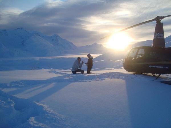  Marriage proposal in the snow at sunset with the Alpine Air helicopter to the right 