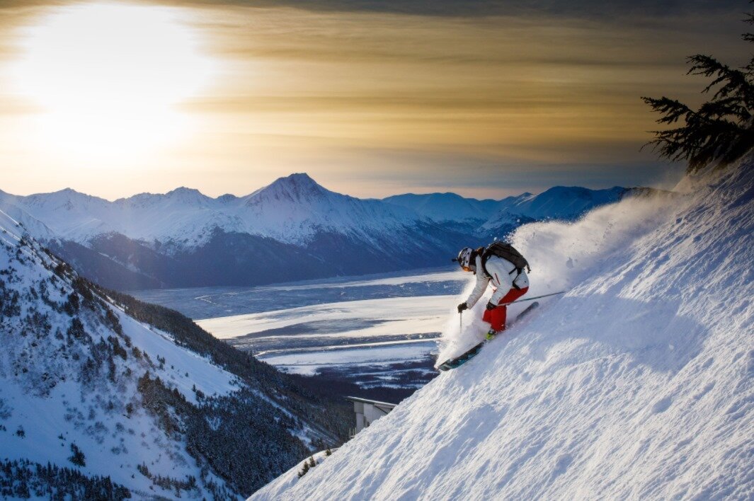  Skier coming down the Alyeska mountain with the sunset in the background 