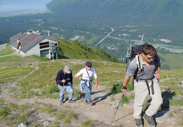  Three hikers heading up Mighty Might hill to the top of Alyeska Mountain 