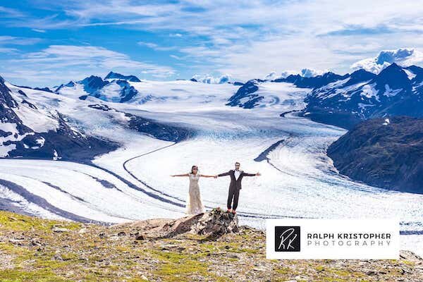  Bride and Groom holding hands in front of glacier and photo taken by Ralph Krisopher Photography 