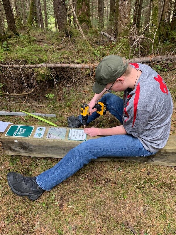  KMTA worker fixing a trail sign 