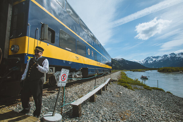 Train Conductor next to river with raft with Chugach Adventure Guides 