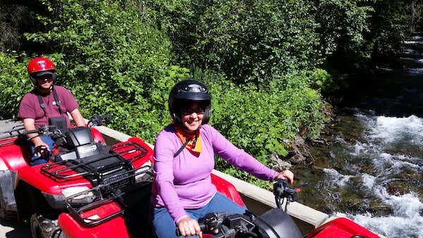  ATV riders going over a bridge on a tour with Alaska Adventure 